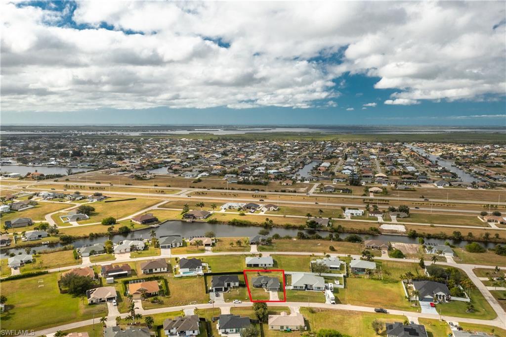 Aerial view of residential area featuring a large body of water