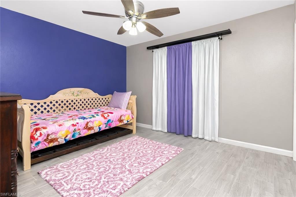 Bedroom with wood finish floors and a ceiling fan