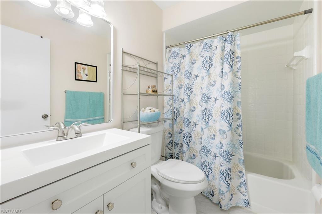 Bathroom featuring vanity and shower / tub combo with curtain