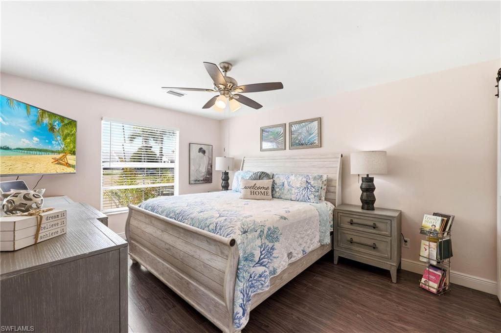 Bedroom featuring dark wood-style floors and ceiling fan