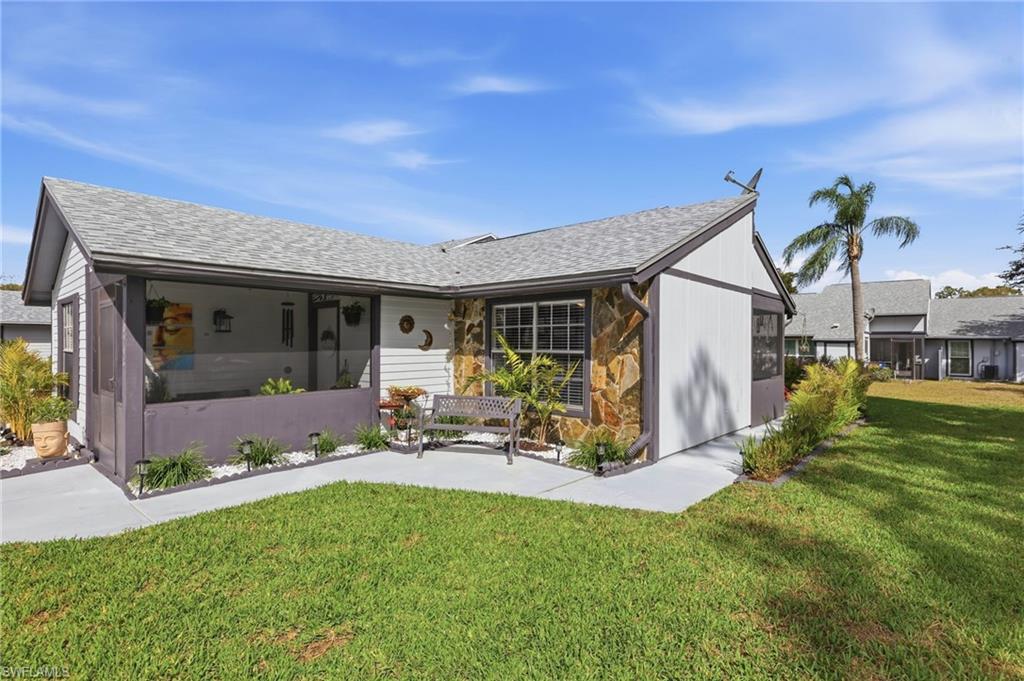 View of front of home with a front lawn and a newer shingle roof