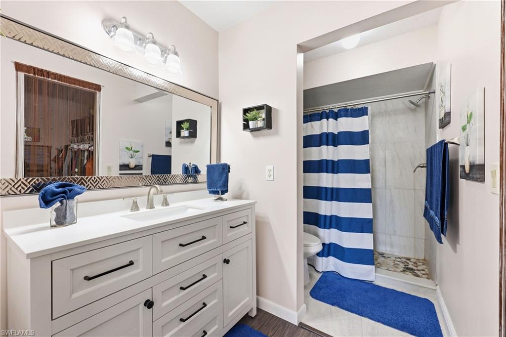 Bathroom featuring vanity and a stall shower