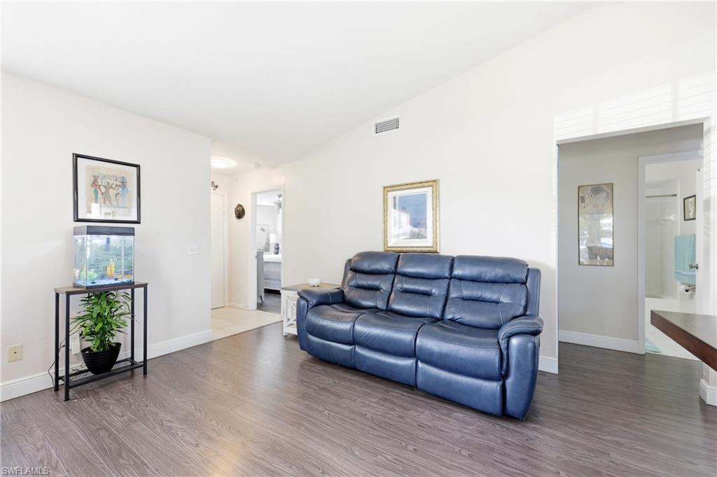 Living area featuring lofted ceiling and wood finished floors