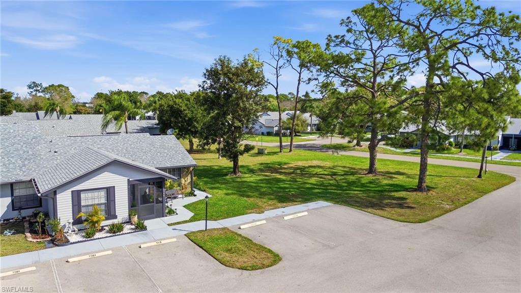 View of home's community featuring uncovered parking, a sunroom, and a residential view