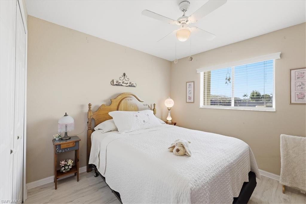 Bedroom with a closet, ceiling fan, and light wood finished floors