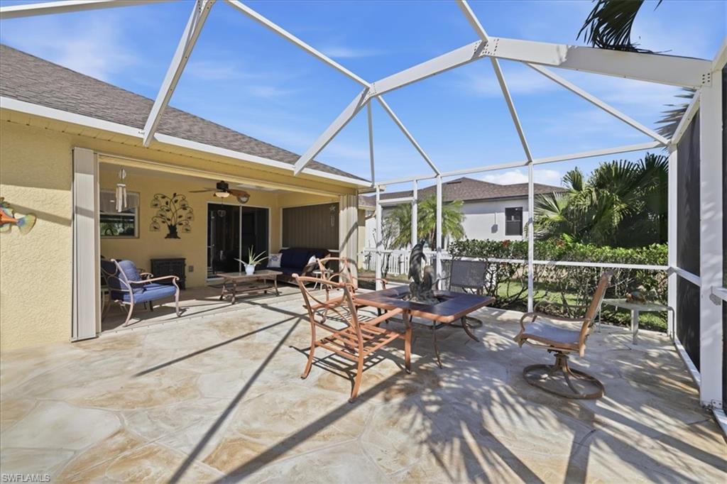 View of patio / terrace with a sunroom, a lanai, outdoor lounge area, and ceiling fan
