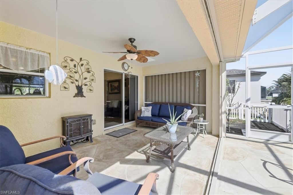 View of patio / terrace featuring a sunroom, outdoor furniture, and ceiling fan