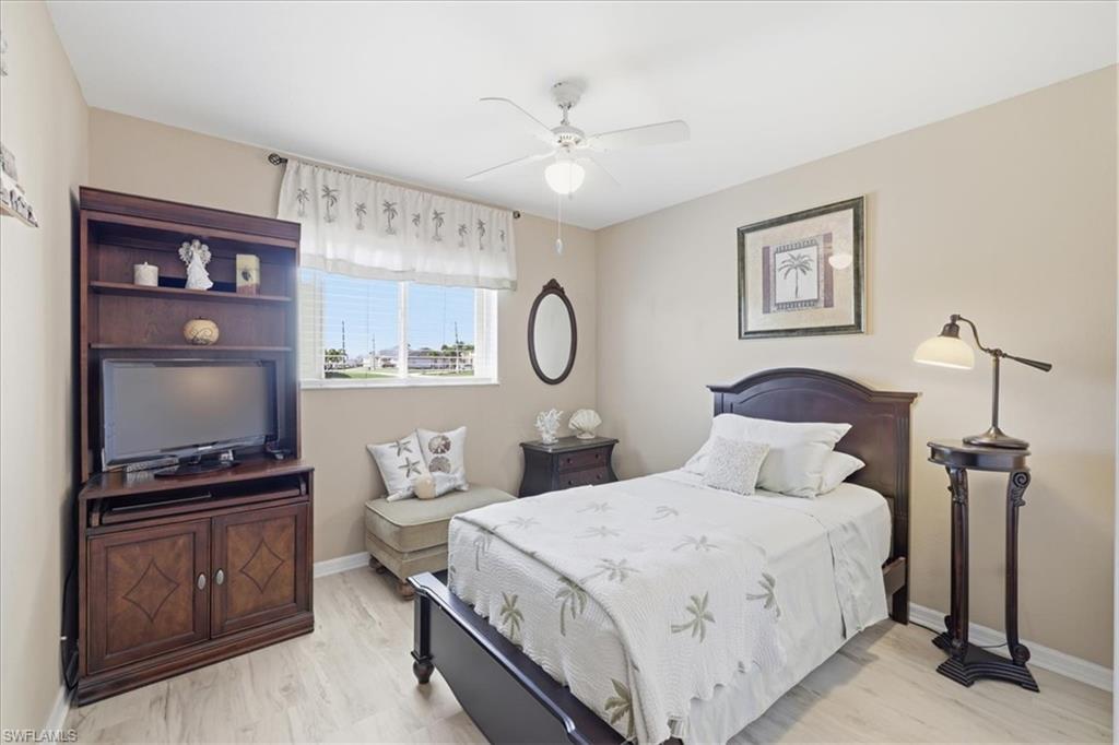 Bedroom with a ceiling fan and light wood-style floors