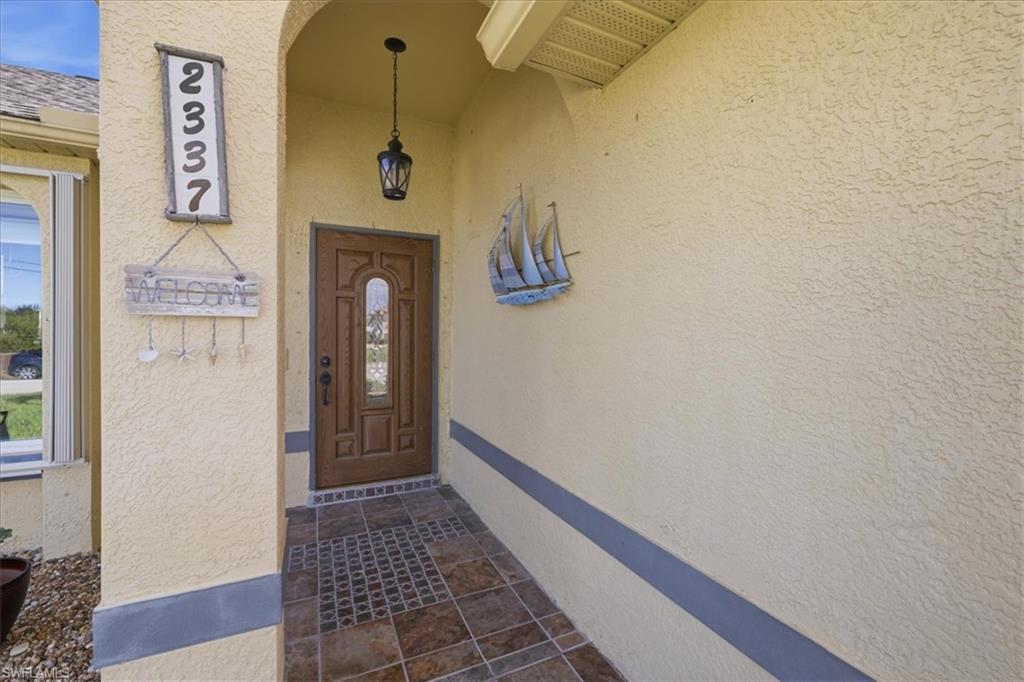 Property entrance featuring stucco siding
