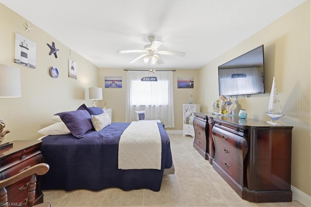 Bedroom featuring a ceiling fan and light tile patterned floors