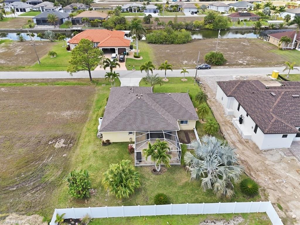Aerial perspective of suburban area featuring a large body of water