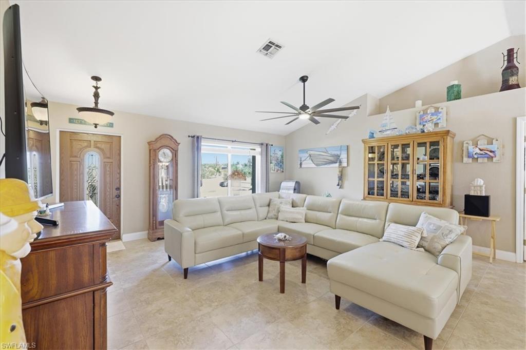 Living room with lofted ceiling and ceiling fan