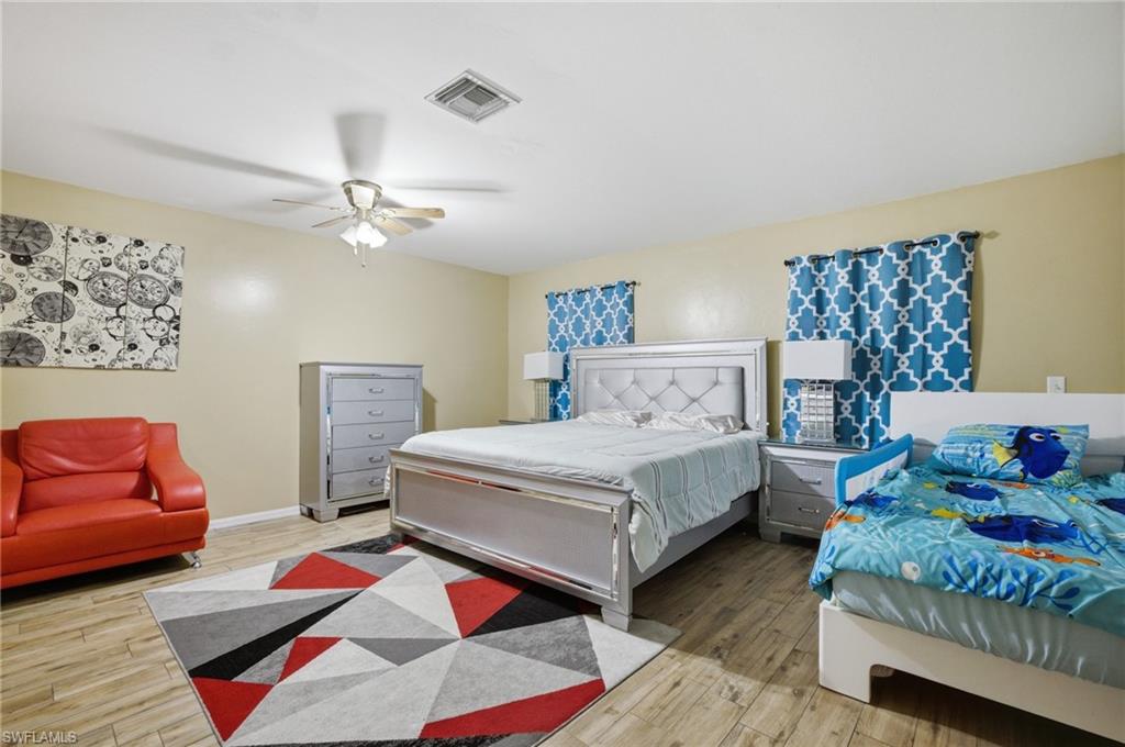 Bedroom featuring light wood-type flooring and a ceiling fan