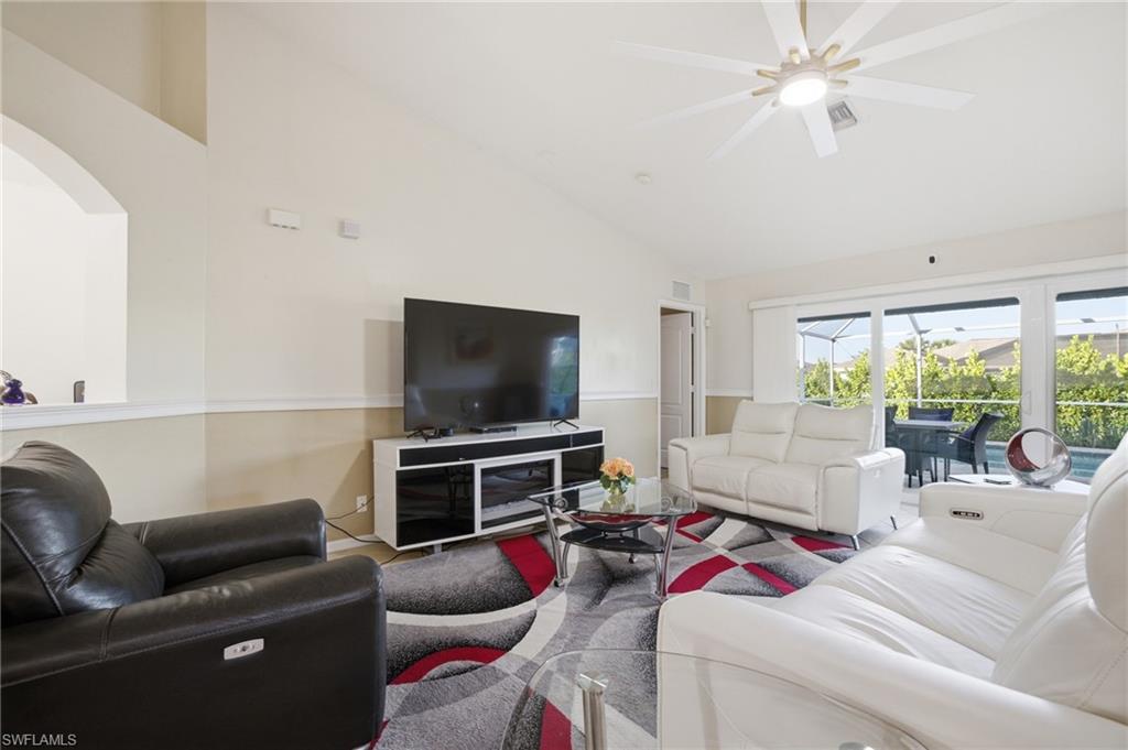 Living area featuring lofted ceiling and a ceiling fan