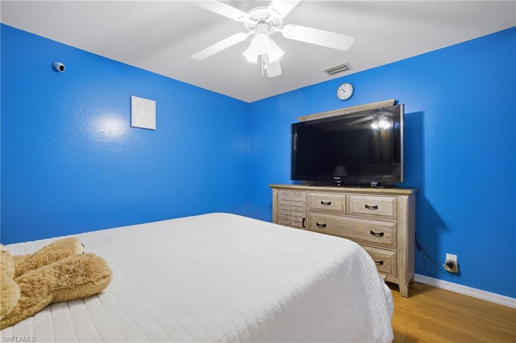Bedroom with light wood-style flooring and a ceiling fan