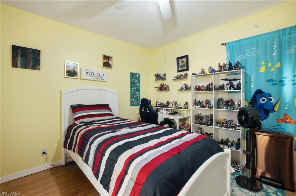 Bedroom with wood finished floors and a ceiling fan