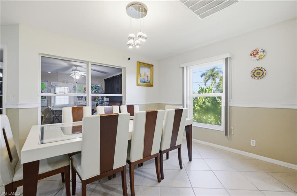 Dining space with ceiling fan and hanging lights
