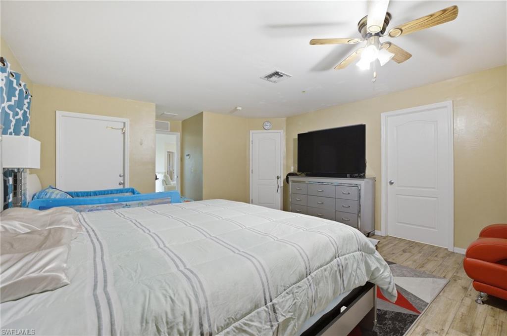 Bedroom with light wood-type flooring and a ceiling fan