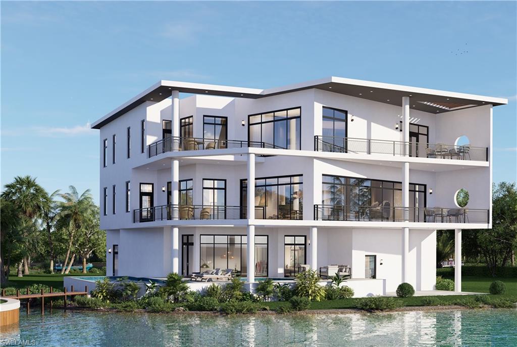 Rear view of property featuring a water view, a balcony, stucco siding, and a patio
