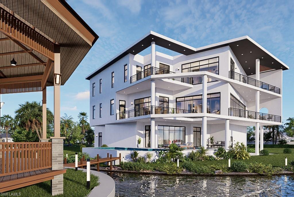 Back of house with stucco siding, a pool, a balcony, and a water view