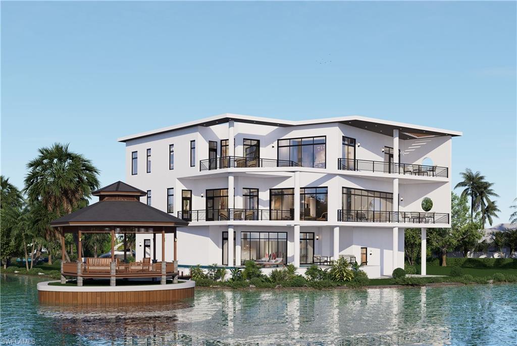 Back of house featuring a water view, a gazebo, stucco siding, and a balcony