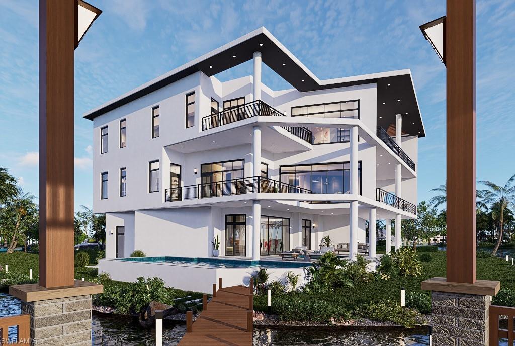 Back of house featuring a balcony, a patio area, stucco siding, and an outdoor pool