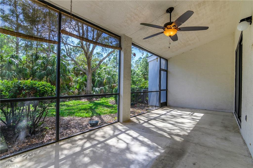 Unfurnished sunroom with ceiling fan and vaulted ceiling