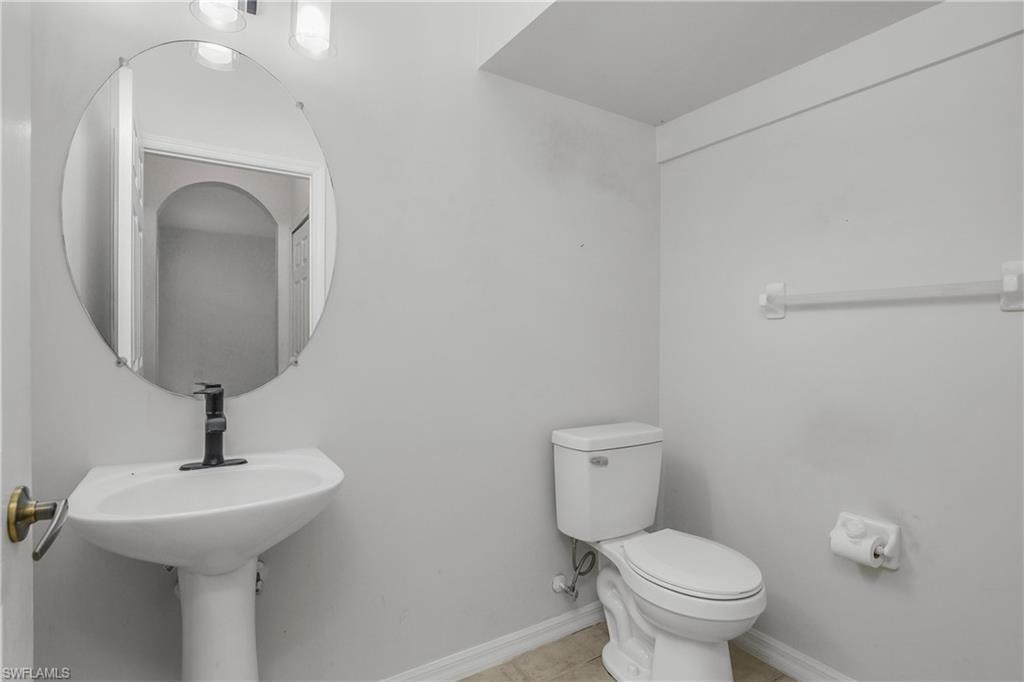 Bathroom featuring toilet and light tile patterned floors