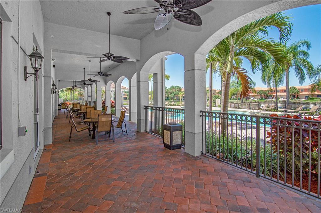 View of patio / terrace featuring outdoor dining area, a community pool, and a ceiling fan
