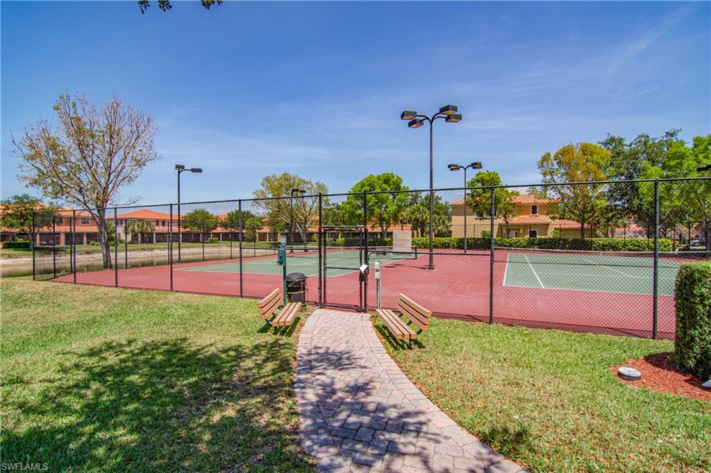 View of tennis court featuring a gate