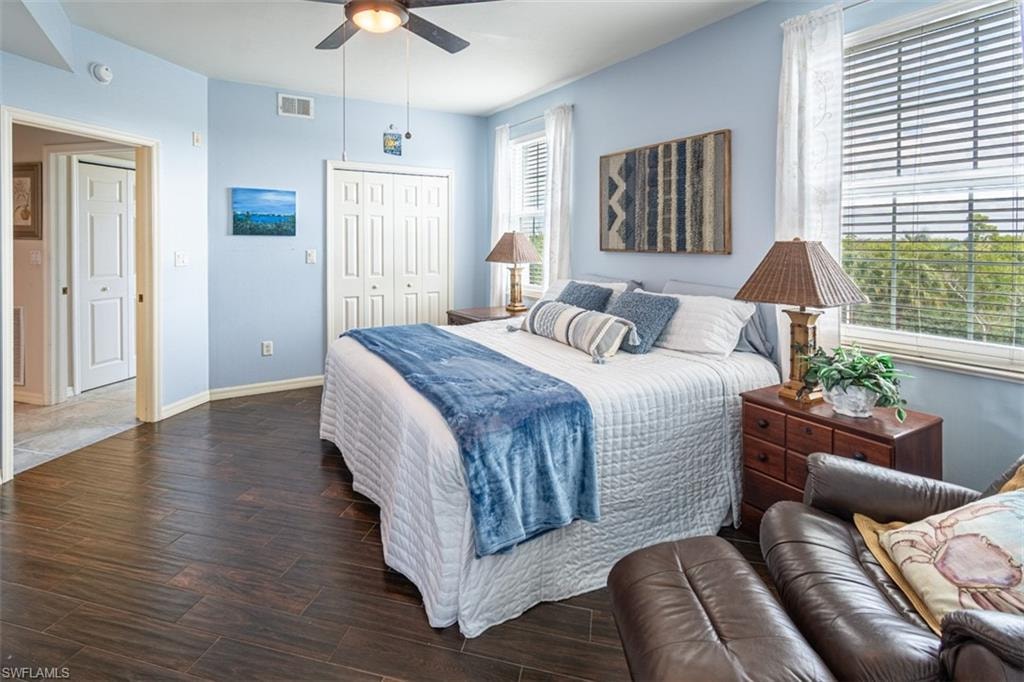 Bedroom with wood finished floors, a closet, and a ceiling fan