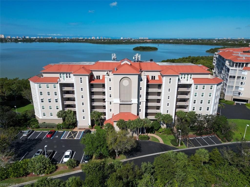 Drone / aerial view of apartment complex / building and a large body of water