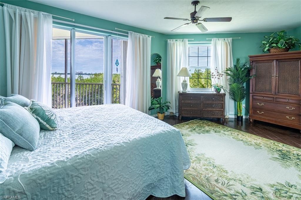Bedroom with access to outside, dark wood-type flooring, and ceiling fan