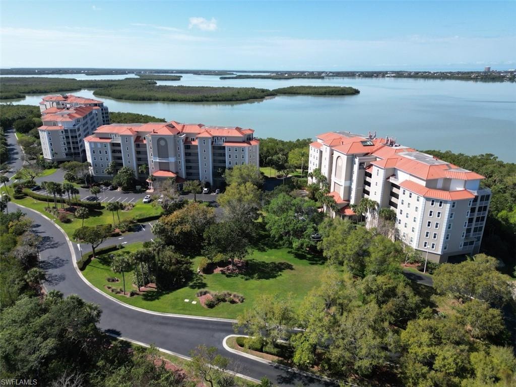 Aerial view of apartment complex and a large body of water