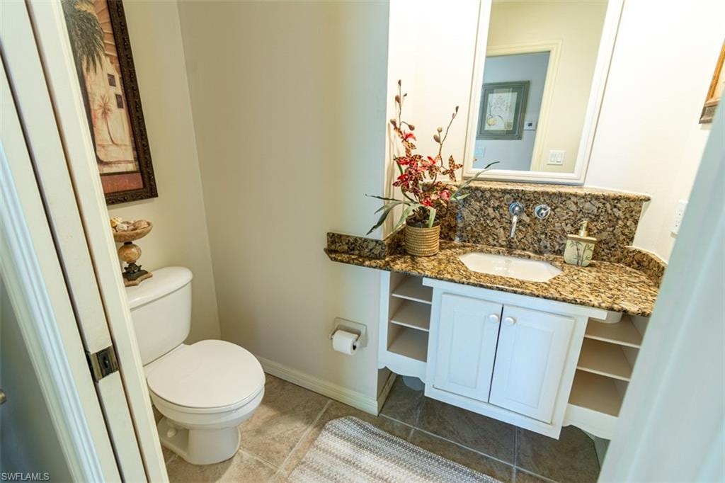 Bathroom with vanity and tasteful backsplash