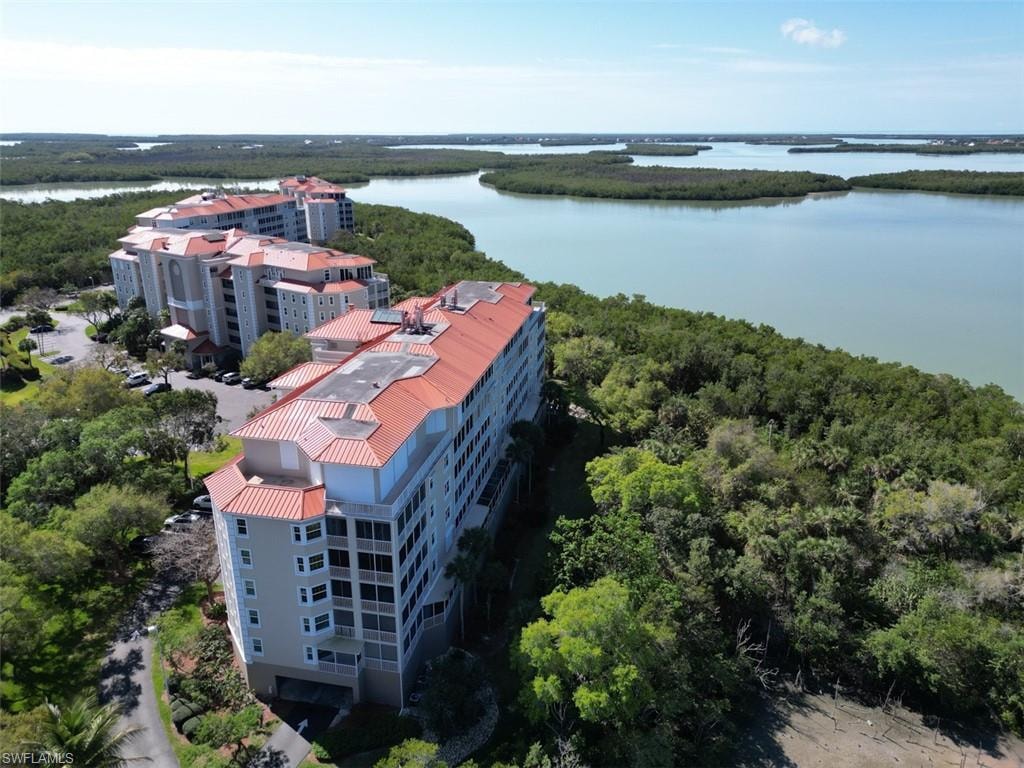 Drone / aerial view of apartment complex / building and a nearby body of water