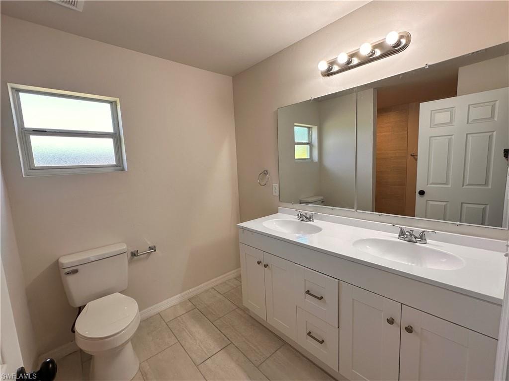 Bathroom with toilet and double vanity
