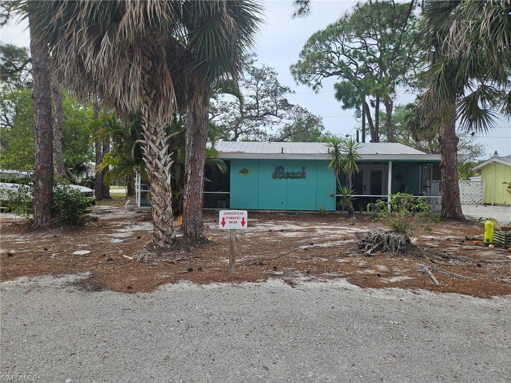 View of front of home featuring a metal roof and a sunroom