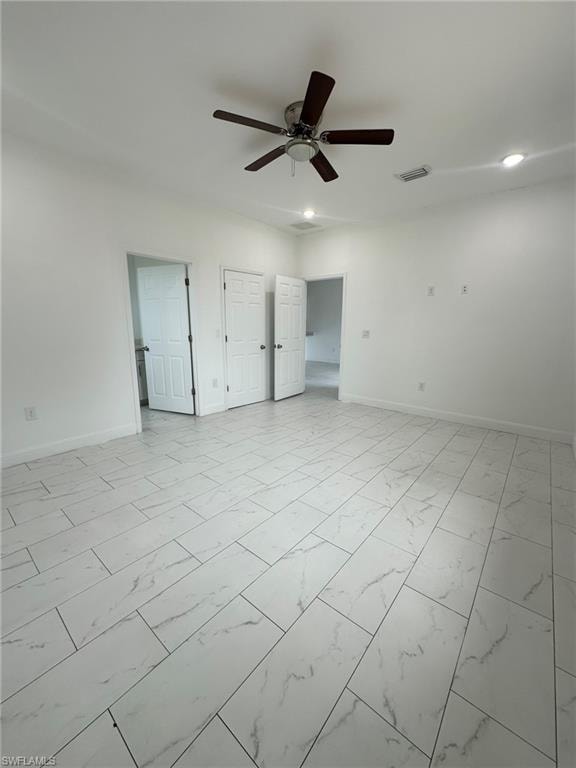 Unfurnished bedroom with light marble finish floors, a ceiling fan, and recessed lighting