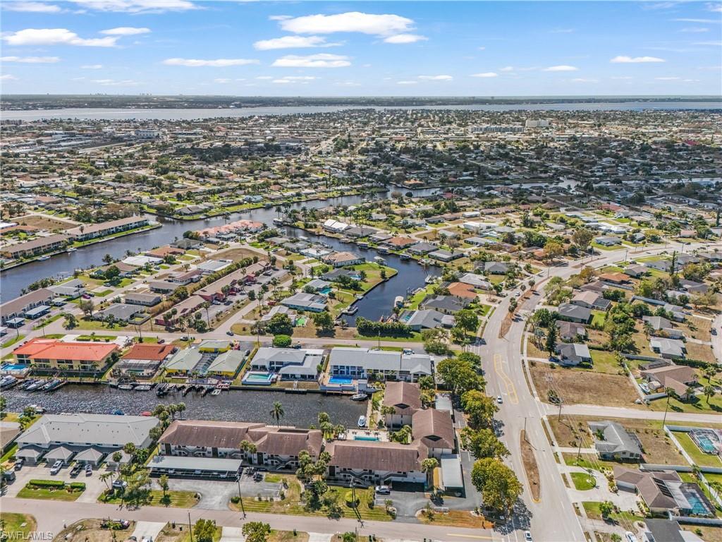 Aerial perspective of suburban area featuring a nearby body of water
