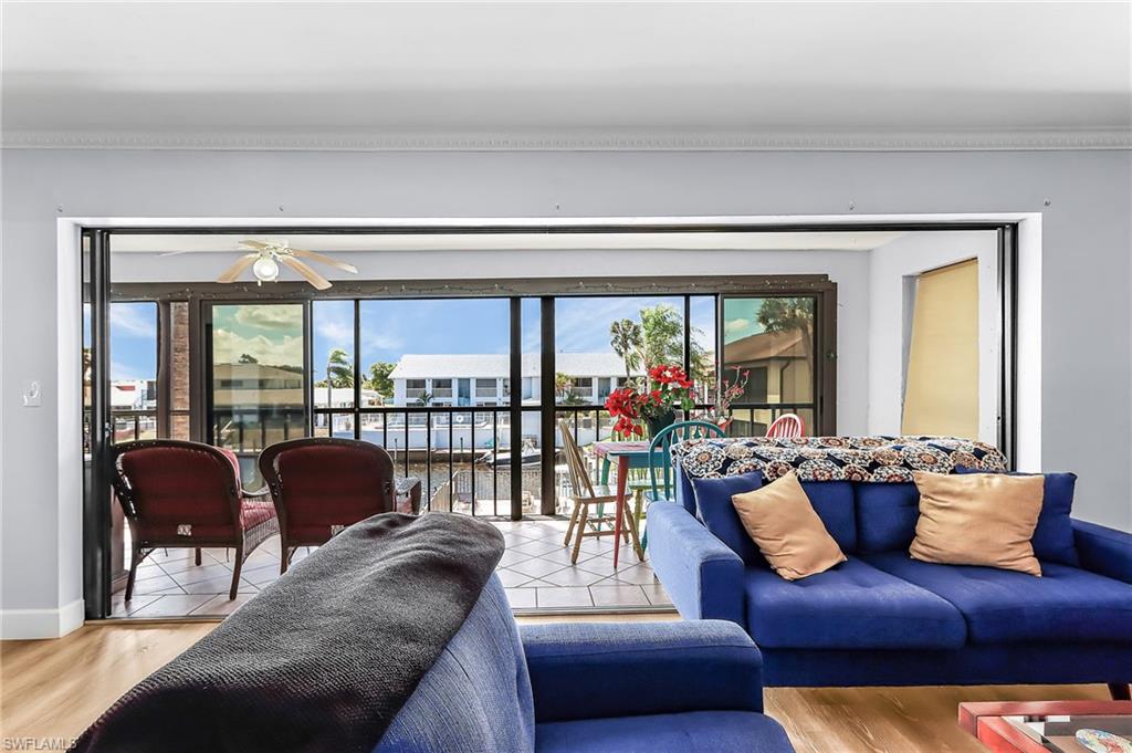Living room featuring plenty of natural light, wood finished floors, and ceiling fan