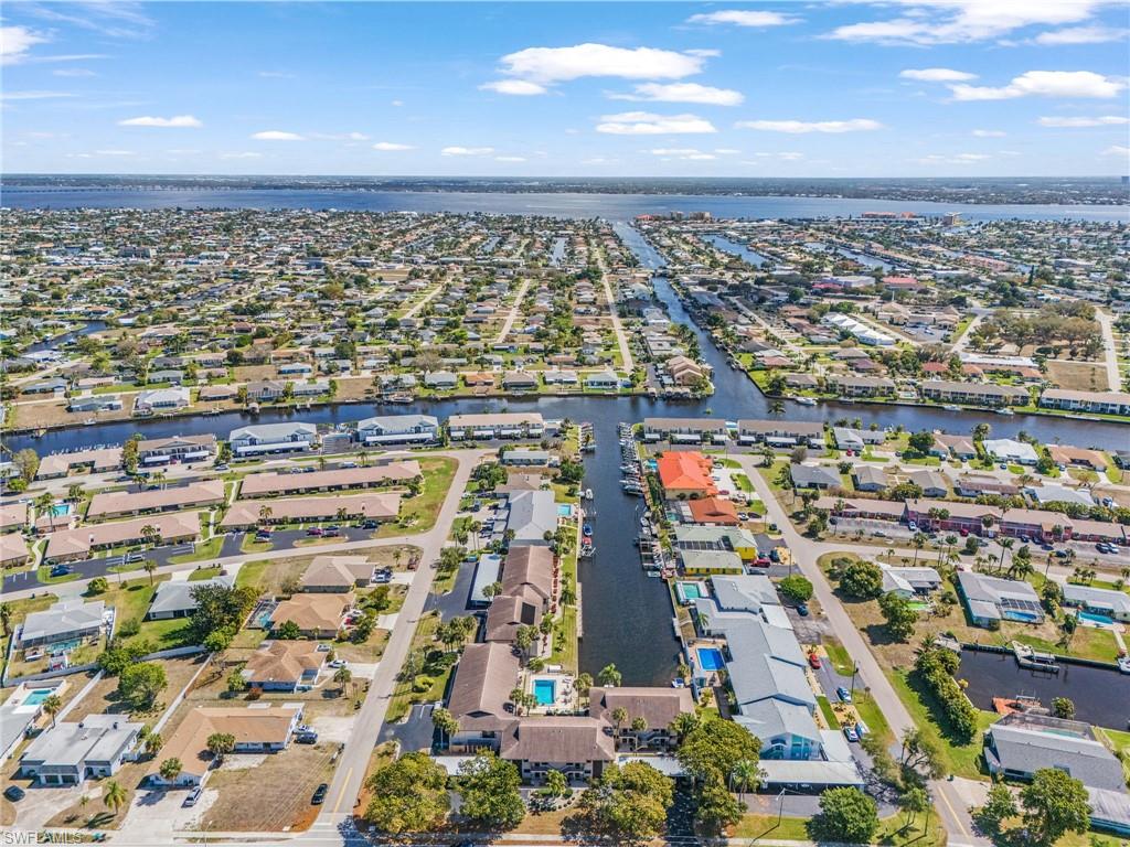 View of property location featuring a large body of water and nearby suburban area