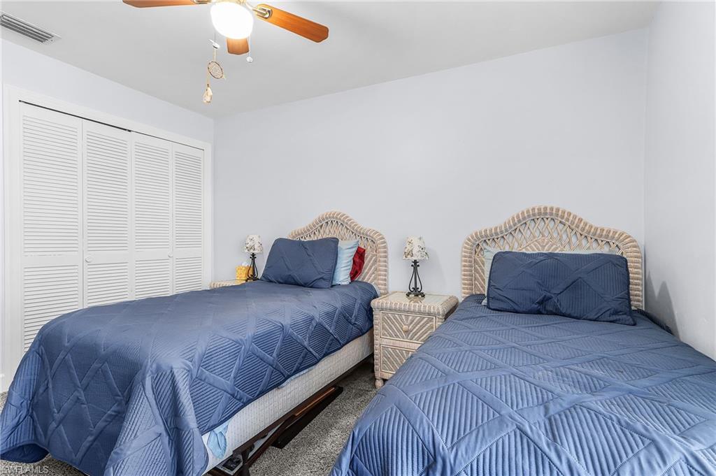 Bedroom featuring carpet floors, a closet, and ceiling fan