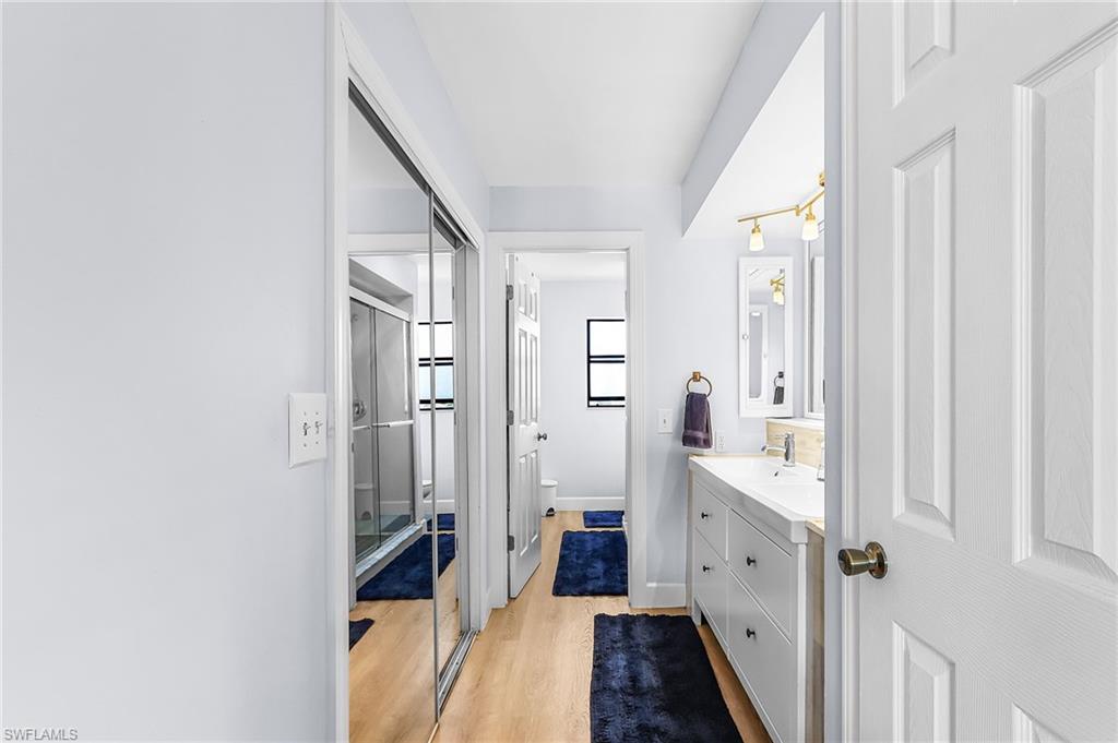 Full bathroom featuring vanity and light wood-style floors