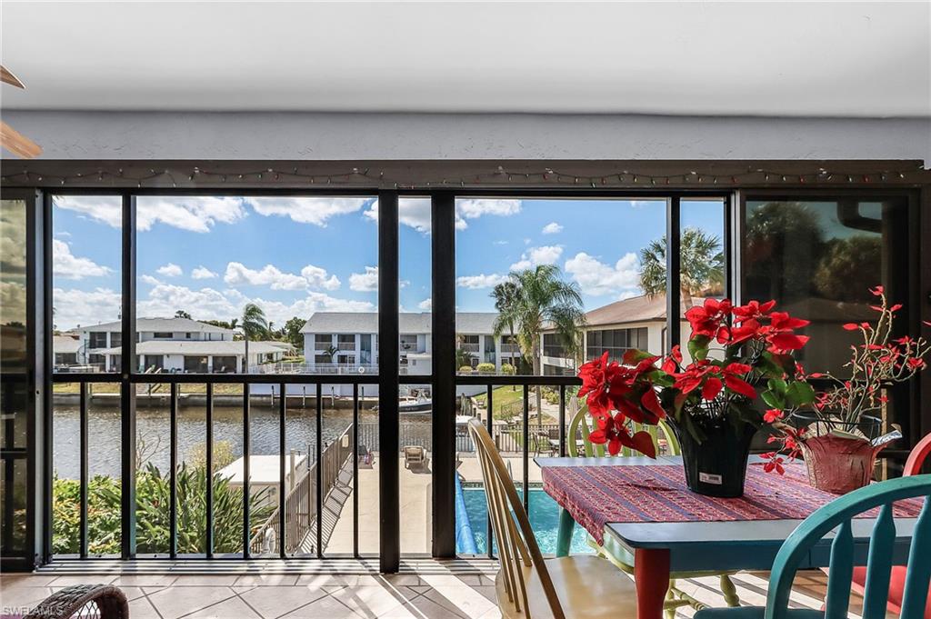 Sunroom featuring a water view