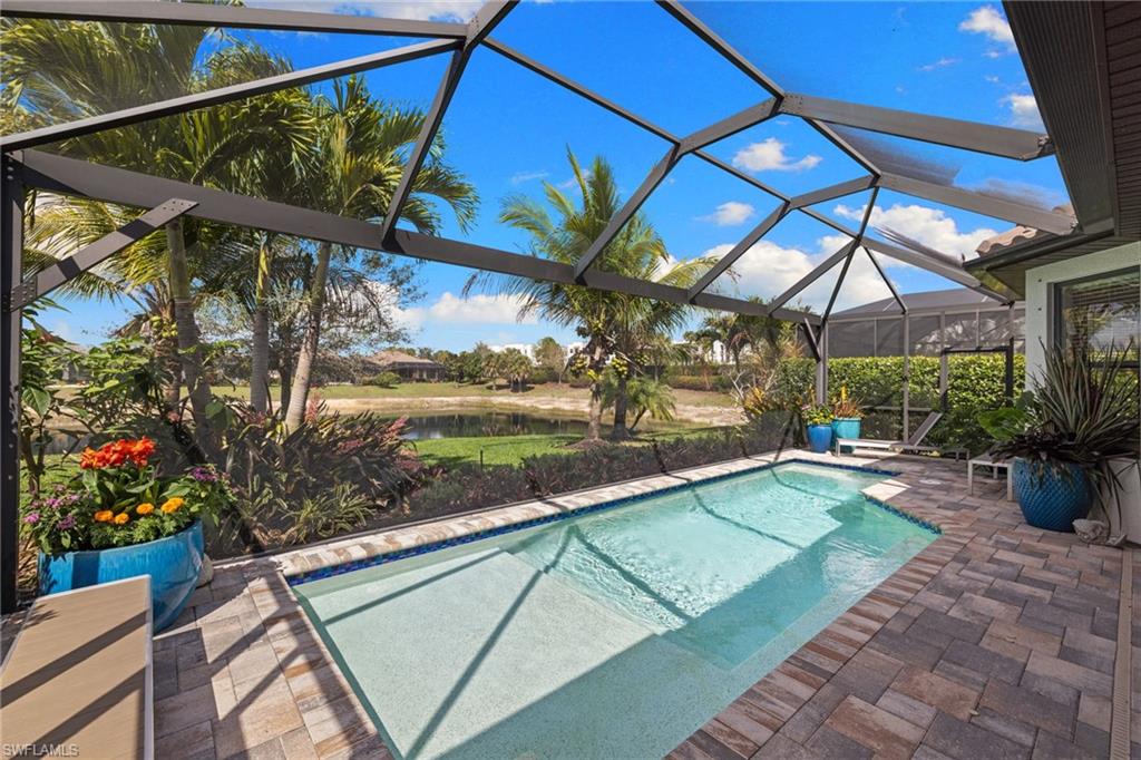 Outdoor pool featuring a patio area, a sunroom, a lanai, and a water view
