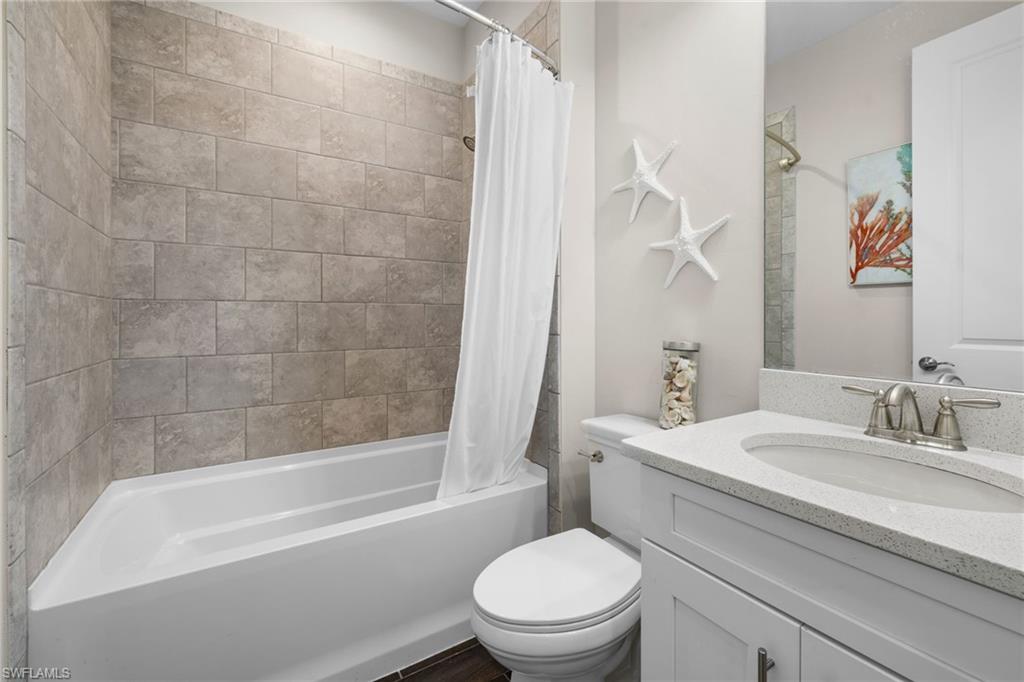 Bathroom featuring vanity and shower / tub combo with curtain