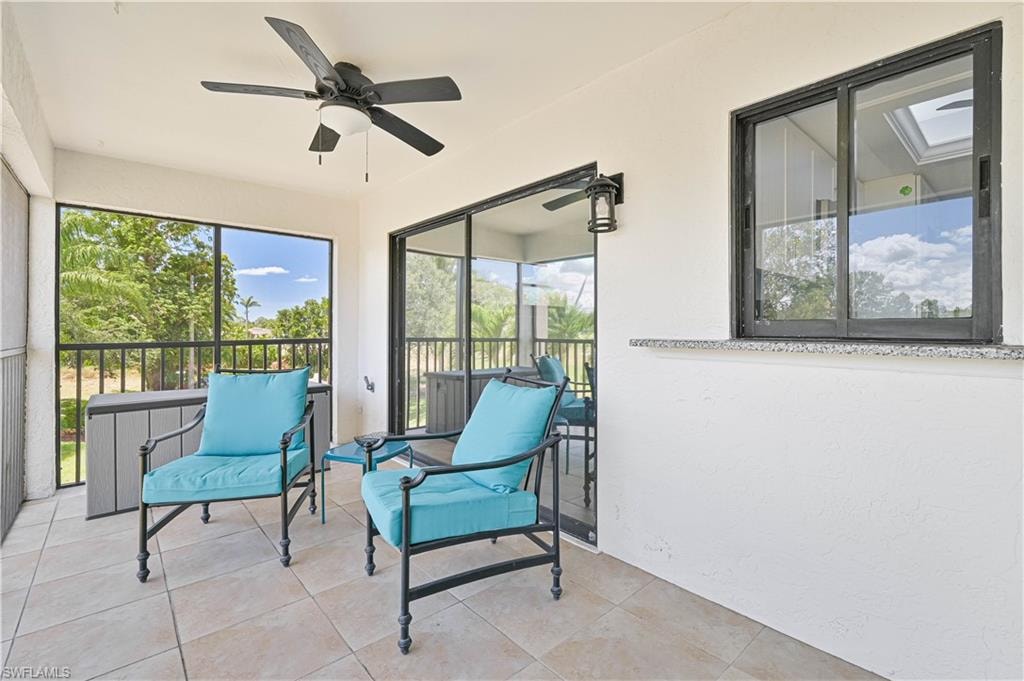 Sunroom with a ceiling fan