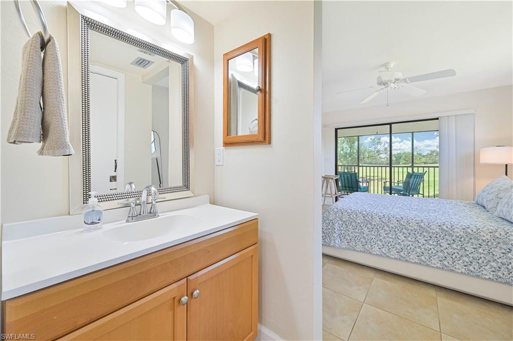 Bathroom featuring vanity, ensuite bathroom, light tile patterned floors, and ceiling fan
