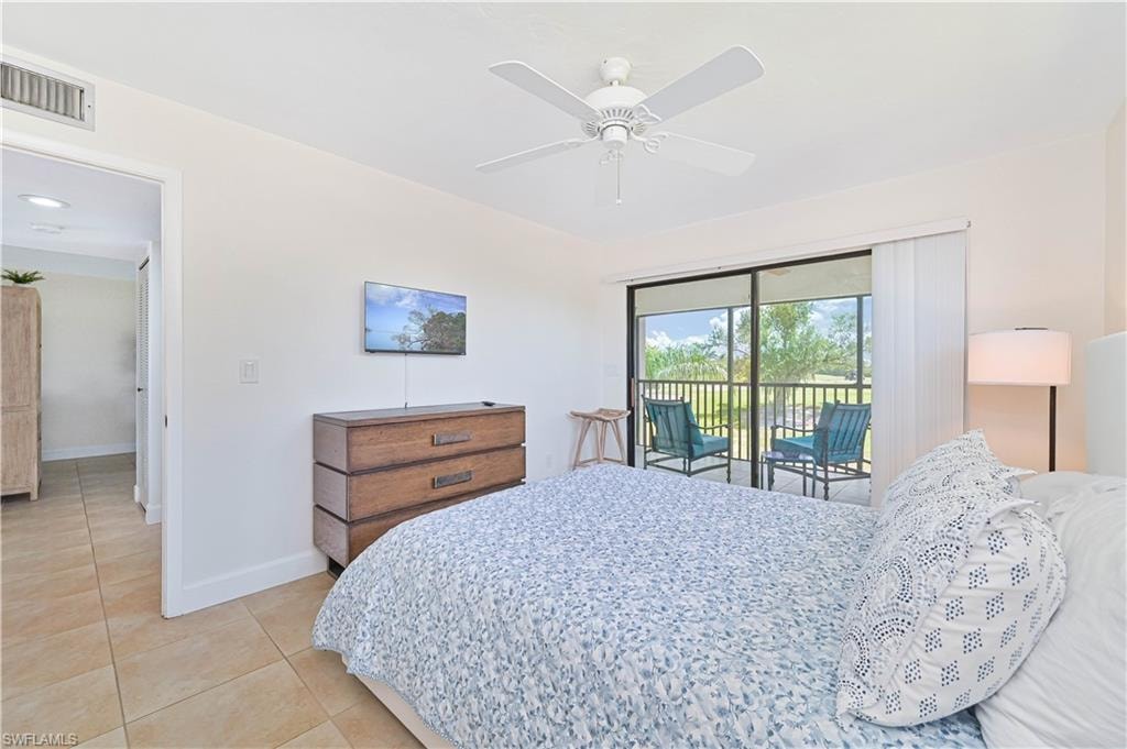 Bedroom with access to exterior, ceiling fan, and light tile patterned floors